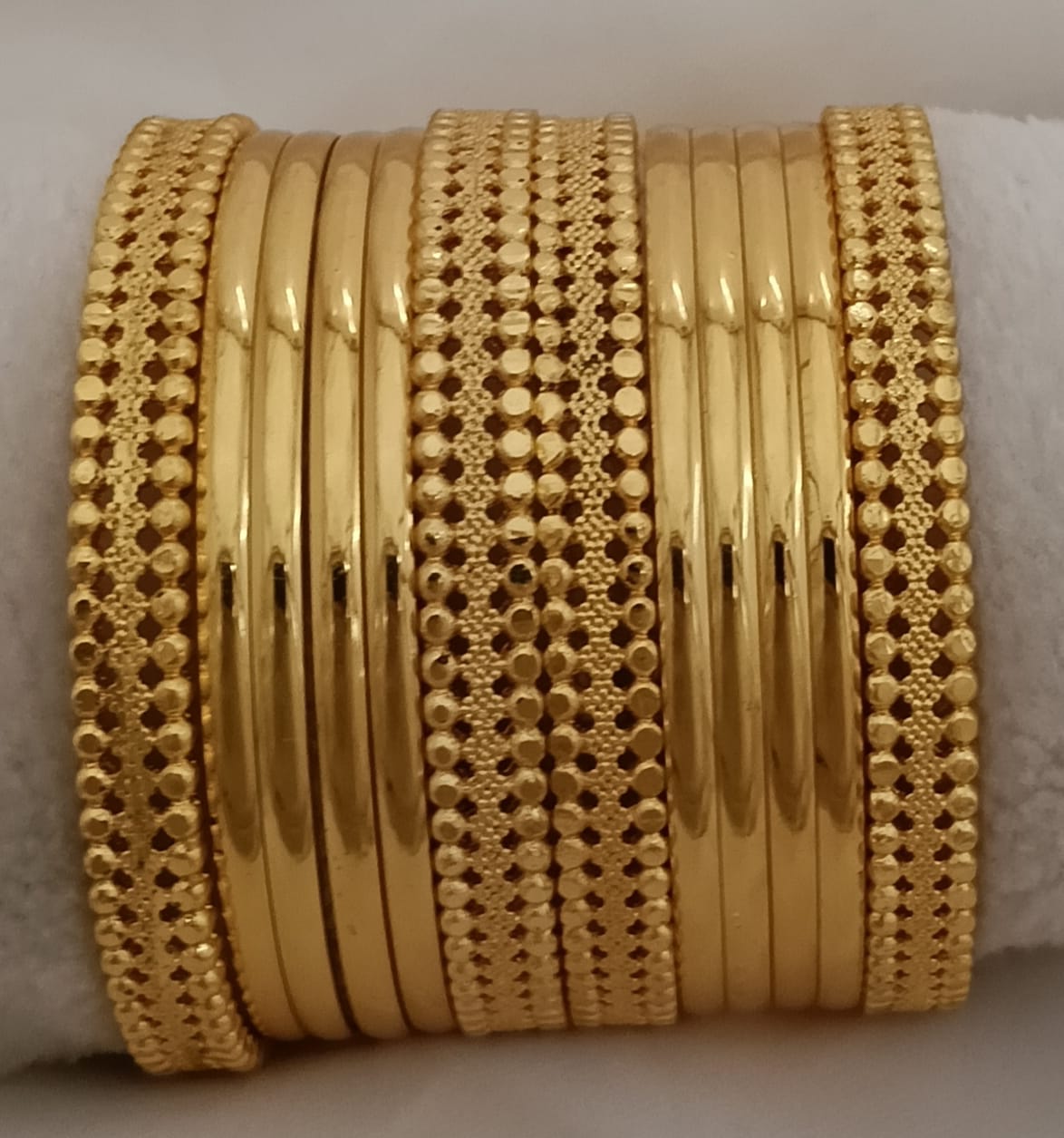 Traditional Indian Gold Plated Metal Bangles Featuring Textured And Studded Patterns