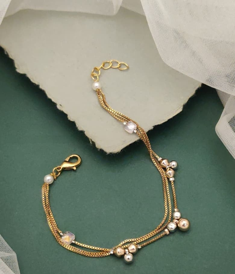 Heirloom Hearts Gold Plated Multi Strand Charm Bracelet Featuring Clover Motifs And Faux Pearls
