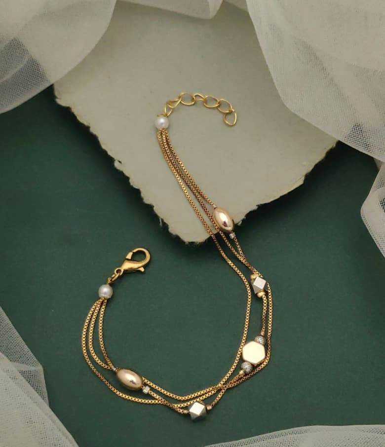 Gemstone Grace Gold Plated Multi Strand Charm Bracelet Featuring Clover Motifs And Faux Pearls