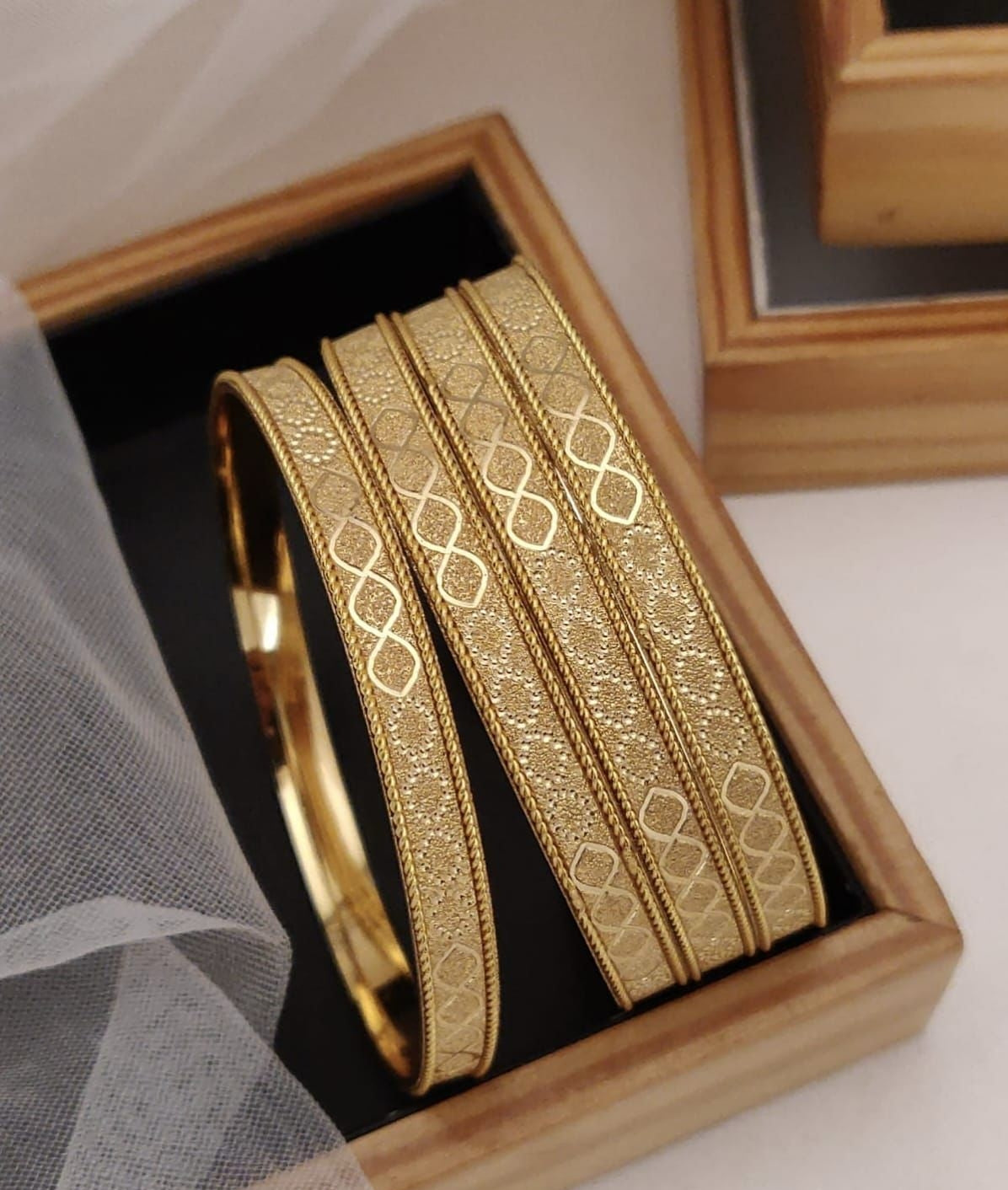 Gold Plated Alloy Bangles Featuring An Intricate Textured Featuring And Infinity Style Patterns