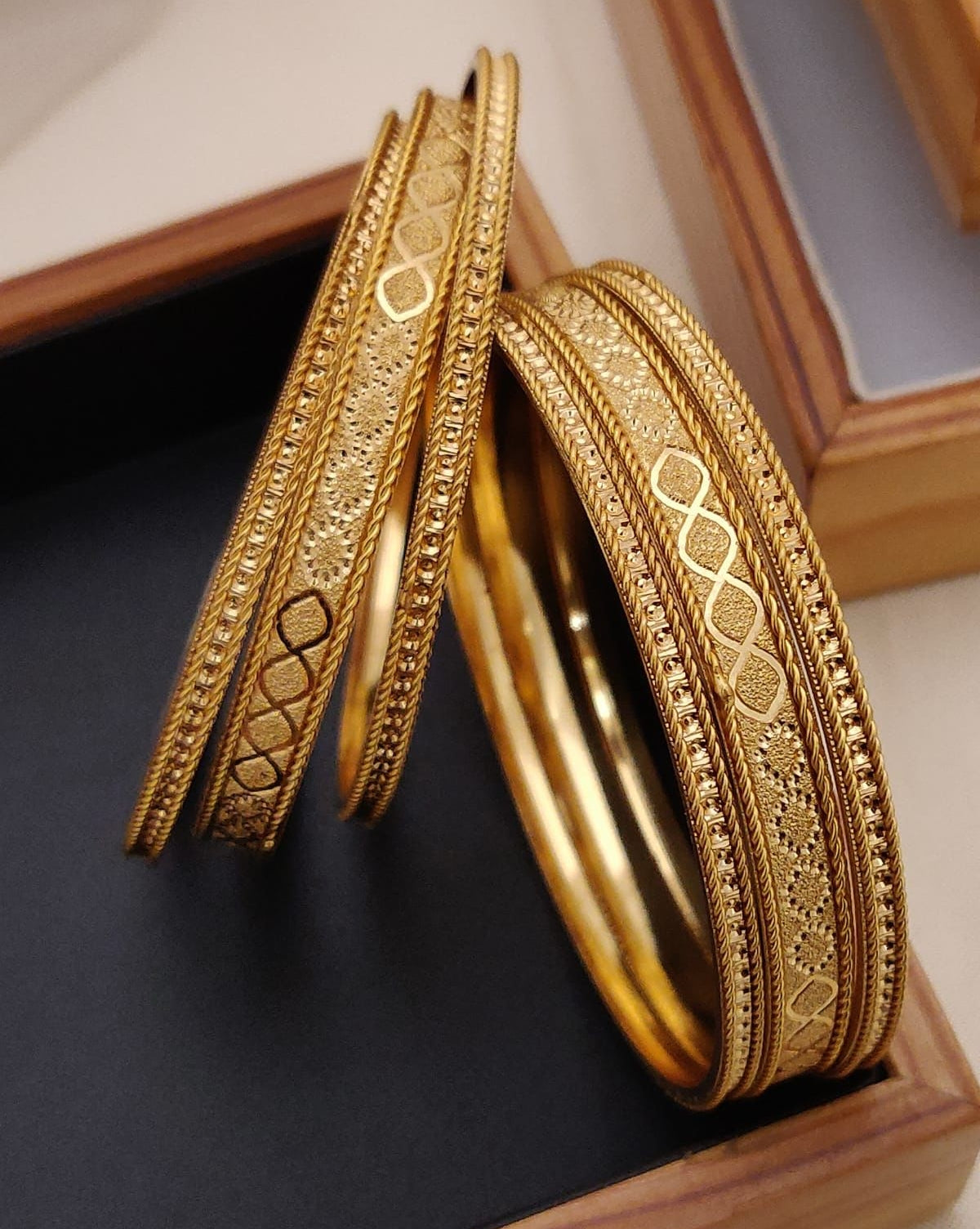 Gold Plated Alloy Bangle Sets Often Featuring A Traditional Greek Key Pattern