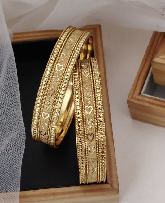 Golden Brass Bangles Featuring A Heart Patterned Featuring