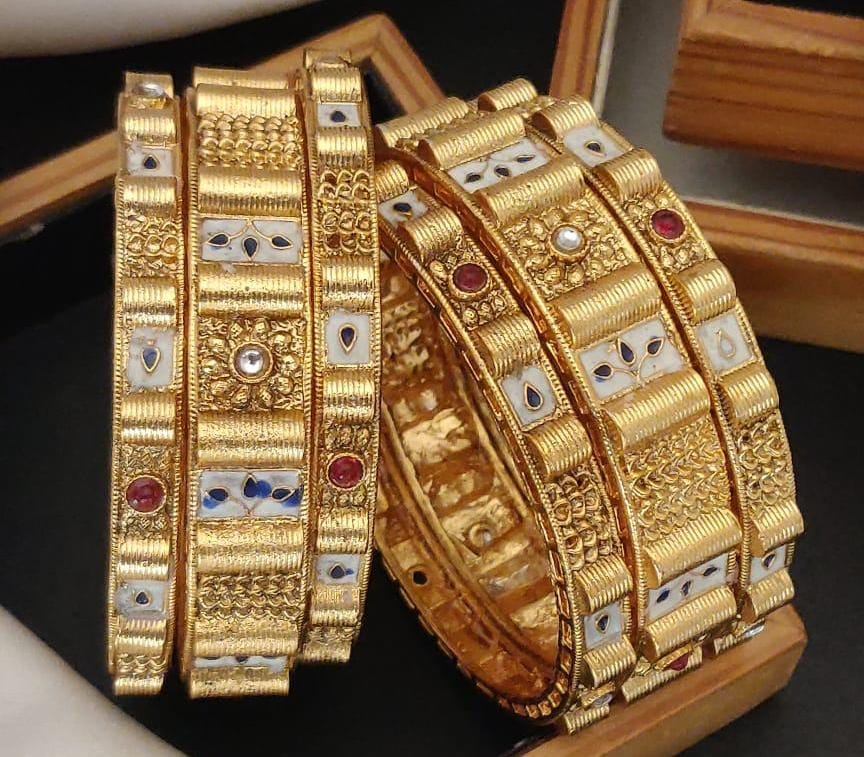 Dazzled Jewels Gold Plated Brass Bangle Set Featuring Intricate Featuring And Studded Stones